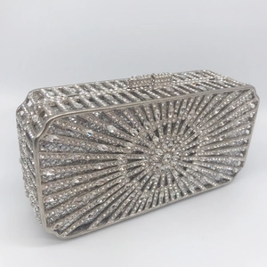 Silver rectangular evening clutch bag with radiant rhinestone patterns and metal clasp