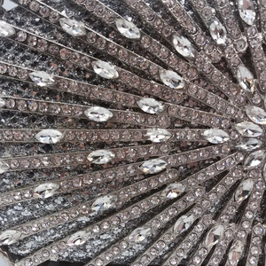 Macro shot of silver evening clutch featuring radial rhinestones and crystal metal detail