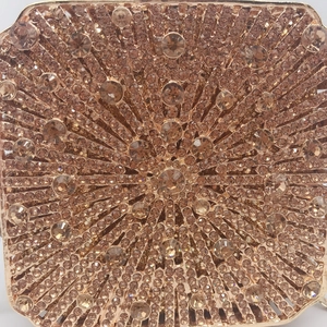 Luxurious rose gold crystal evening clutch bag with radial sunburst rhinestone pattern
