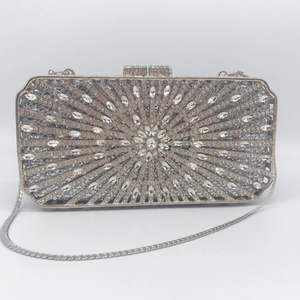 Detailed macro view of silver evening clutch featuring radial sunflower diamond patterns