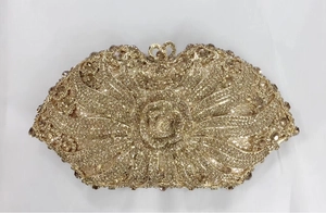Detail of champagne gold evening clutch featuring 3D rose flower and crystal rhinestones