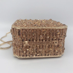 Close-up of champagne gold rhinestone evening bag with luxury crystal mesh and chain
