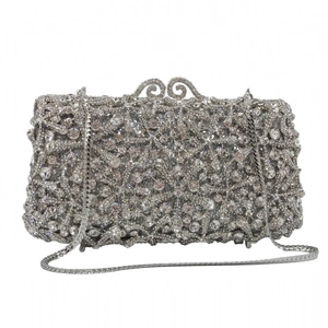 Macro view of crystal encrusted silver evening clutch featuring floral lace pattern