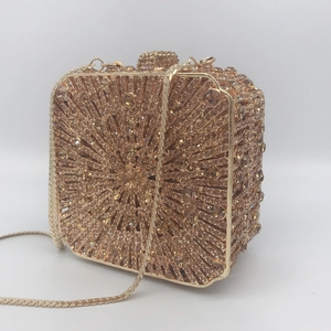 Detail of gold box clutch with champagne rhinestones in a sunburst pattern