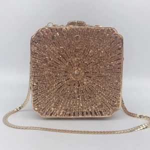 Close-up of champagne rhinestones in a sunburst pattern on the luxury evening clutch