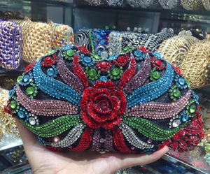Detail of evening clutch featuring red rose rhinestone pattern and multi-color crystal inlay