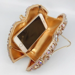 Detailed view of luxury rhinestone evening bag showing interior space with a smartphone