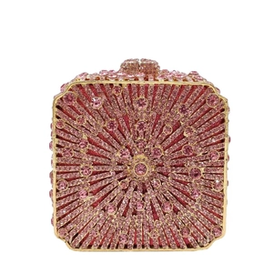 Close-up of pink rhinestones in radial pattern on a gold-framed luxury clutch bag