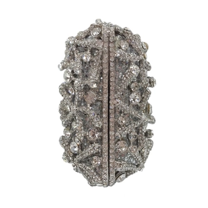 Macro detail of silver starfish evening clutch featuring shimmering crystal encrusted surface
