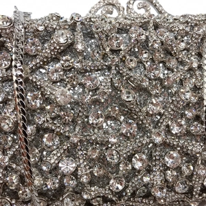 Detailed macro view of starfish evening bag with sparkling crystals and silver chain