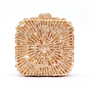 Macro detail of champagne gold evening bag with radial rhinestone patterns and jewel clasp