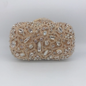 Detailed view of luxury gold metal clutch bag with intricate crystal and diamond patterns