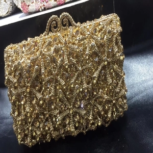 Macro view of golden starfish evening clutch with crystal inlay and hollow metal lock