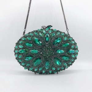 Elegant emerald green crystal clutch bag with oval hardshell and metallic chain strap
