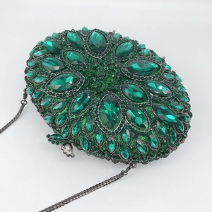 Elegant emerald green oval evening clutch bag with crystal embellishments and chain strap