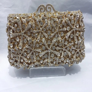 Macro detail of gold evening clutch featuring starburst crystal patterns and retro clasp