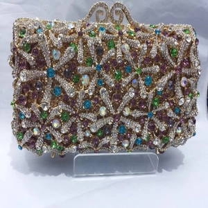 Close-up of golden hollow metal frame and colorful rhinestone starfish pattern on clutch