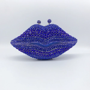 Macro detail of the dark blue crystal-encrusted lip-shaped evening clutch bag