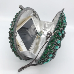 Luxury green rhinestone evening clutch with chain strap showing spacious interior capacity