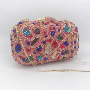 Detailed macro view of rectangle hard-shell evening clutch with multi-colored crystals