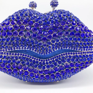 Close-up of blue crystal rhinestones and silver ball clasp on lip-shaped evening clutch