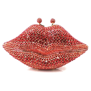 Macro shot of red crystal lip clutch showing sparkling rhinestones and gold frame