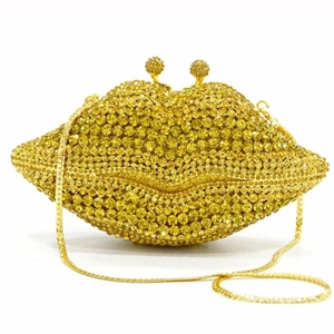 Detail of lip-shaped evening bag with sparkling rhinestones and gold chain strap