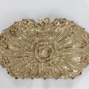 Gold evening clutch bag with hollow metal roses and rhinestones for formal occasions