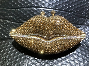 Detailed view of the gold rhinestone lips evening clutch with shimmering crystal buckle