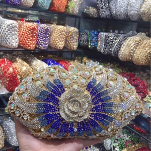 Luxury rose pattern evening bag with blue and silver crystals on a gold metal frame