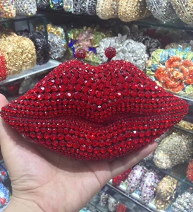 Close-up of a sparkling red lip-shaped evening clutch bag adorned with crystals