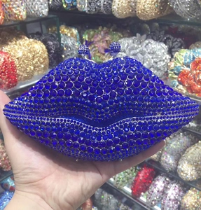Detail of a dark blue lip-shaped evening clutch bag encrusted with sparkling rhinestones