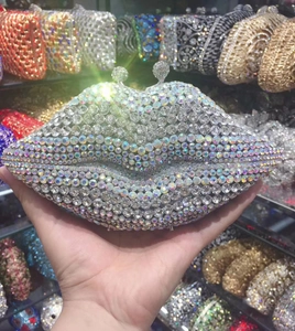 Detailed view of a silver crystal-encrusted lip-shaped clutch bag with metal ball clasp