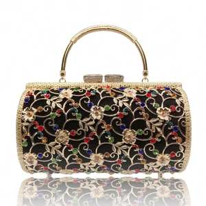 Elegant hollow metal evening bag with colorful rhinestones and gold handle on white background