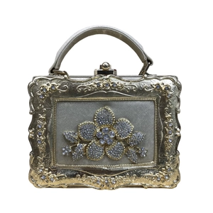 Elegant gold evening handbag with sparkling rhinestone flower and vintage frame handle