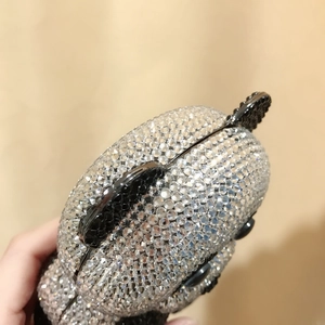 Close-up of sparkling crystal rhinestones on a panda-shaped evening clutch bag