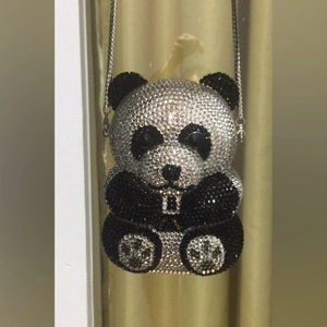 Detail of panda animal clutch bag featuring full rhinestone crystal paving and silver chain
