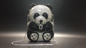 Detail of panda evening clutch bag with black and white crystal rhinestones and chain