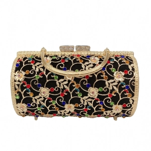 Close-up of hollow metal evening bag featuring colorful rhinestones and floral vine patterns