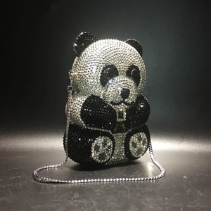 Close-up of the sparkling black and white rhinestone panda evening clutch and silver chain