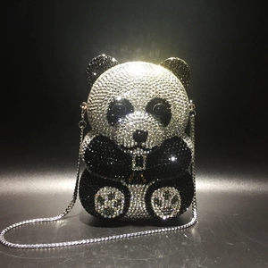 Close-up of a panda-shaped evening bag with black and white crystal embellishments