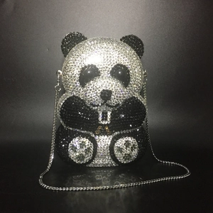 Macro shot of handcrafted crystal-encrusted panda evening bag with silver chain detail