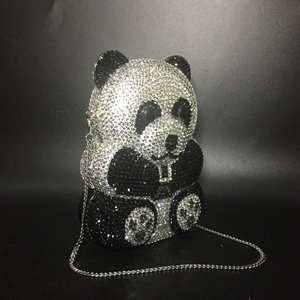 Macro detail of handmade panda crystal evening bag with intricate silver and black rhinestones