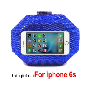 Macro shot of a navy blue crystal evening clutch showing capacity to fit a smartphone