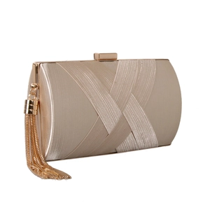 Detail of champagne gold satin evening bag featuring crisscross fabric and long tassels