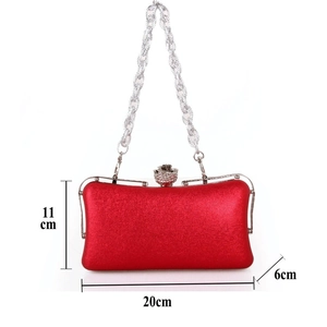 Red evening clutch with flower buckle and dimensions 20cm x 11cm x 6cm on white background