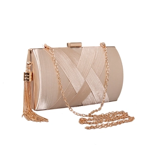 Elegant champagne gold silk woven clutch bag with long metal tassel and chain strap