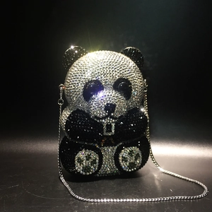 Macro detail of the panda crystal clutch bag showing the intricate black and white rhinestones