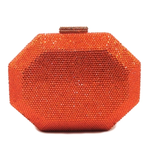Close-up of an octagonal rhinestone evening clutch bag in vibrant orange with crystals