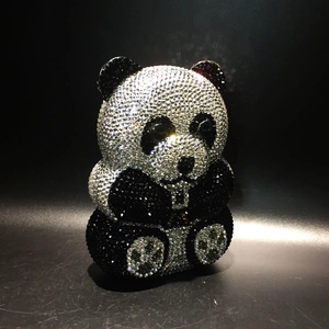 Close-up detail of a handmade panda evening clutch bag with black and white crystals